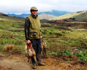 Happy hunter with pheasants 