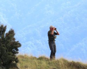 Hunter looking over Poronui's landscape with binoculars