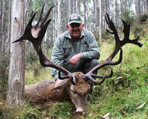 Hunter holding his sika trophy