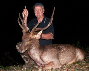 hunter showing his trophy stag