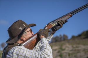 hunter aiming at pheasant