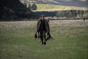 hunter walking back with pheasants on hands